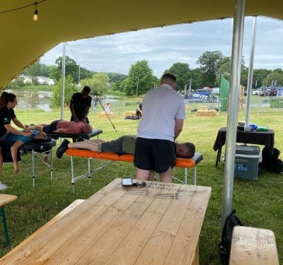 the livewell team performing festival massage backstage for artists and also for event attendees