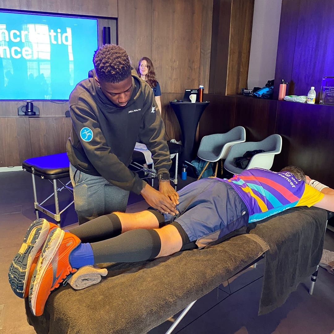 leon performing sports massage at the london marathon event with on-site massage