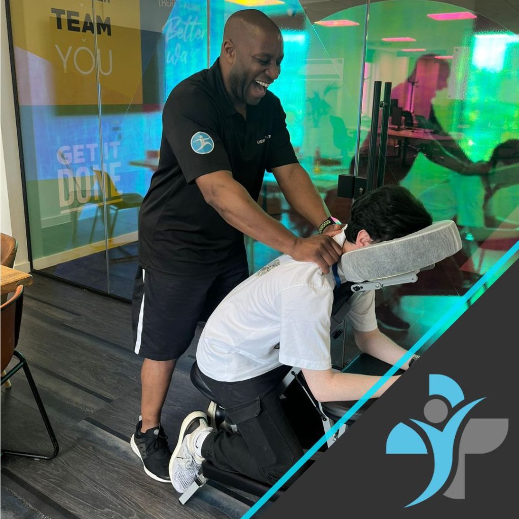 Mike performing chair massage at Zuto offices in Manchester