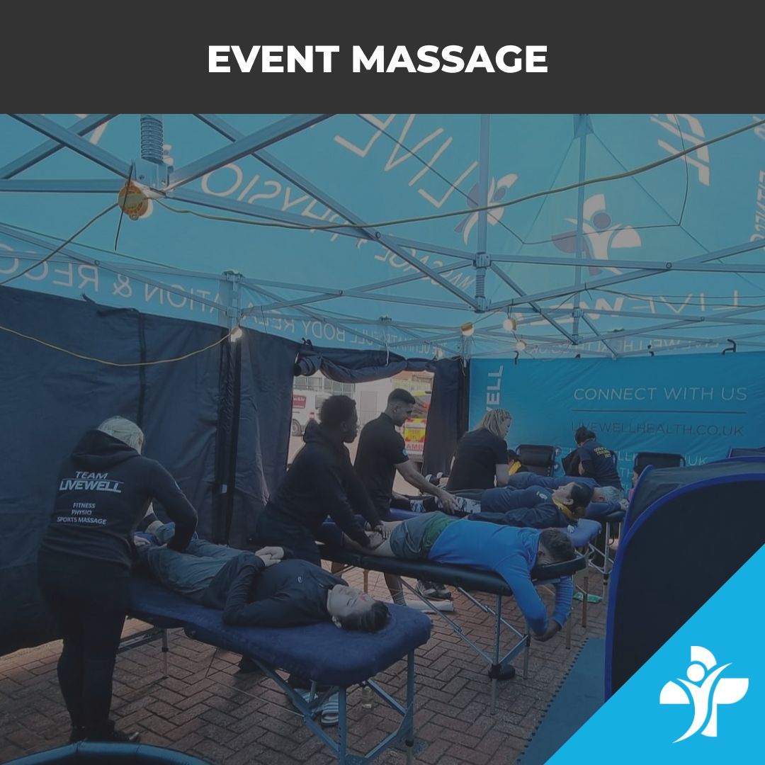 Event massage setup under a blue canopy with multiple clients lying on massage tables as therapists work.